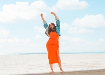 Ali Chanel in an orange dress