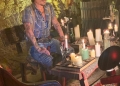 Johnny Depp sitting besides candles