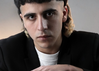 Man in black suit with mullets