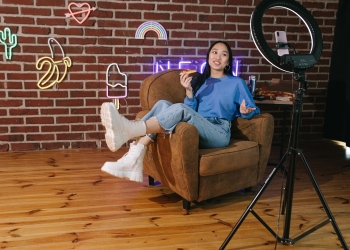 A Woman Recording Herself with a Smartphone while Eating