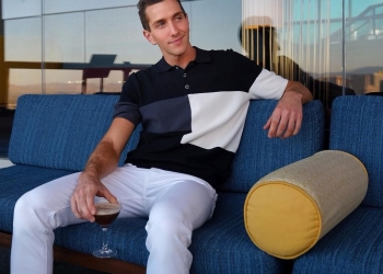 Matt Peterson wearing white pants and color striped t-shirt