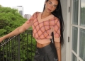 Dua Lipa posing in the balcony