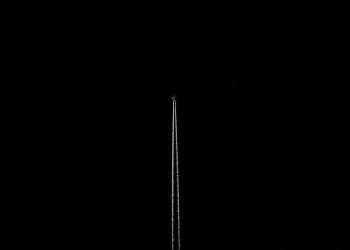 black wallpaper with a flying airplane