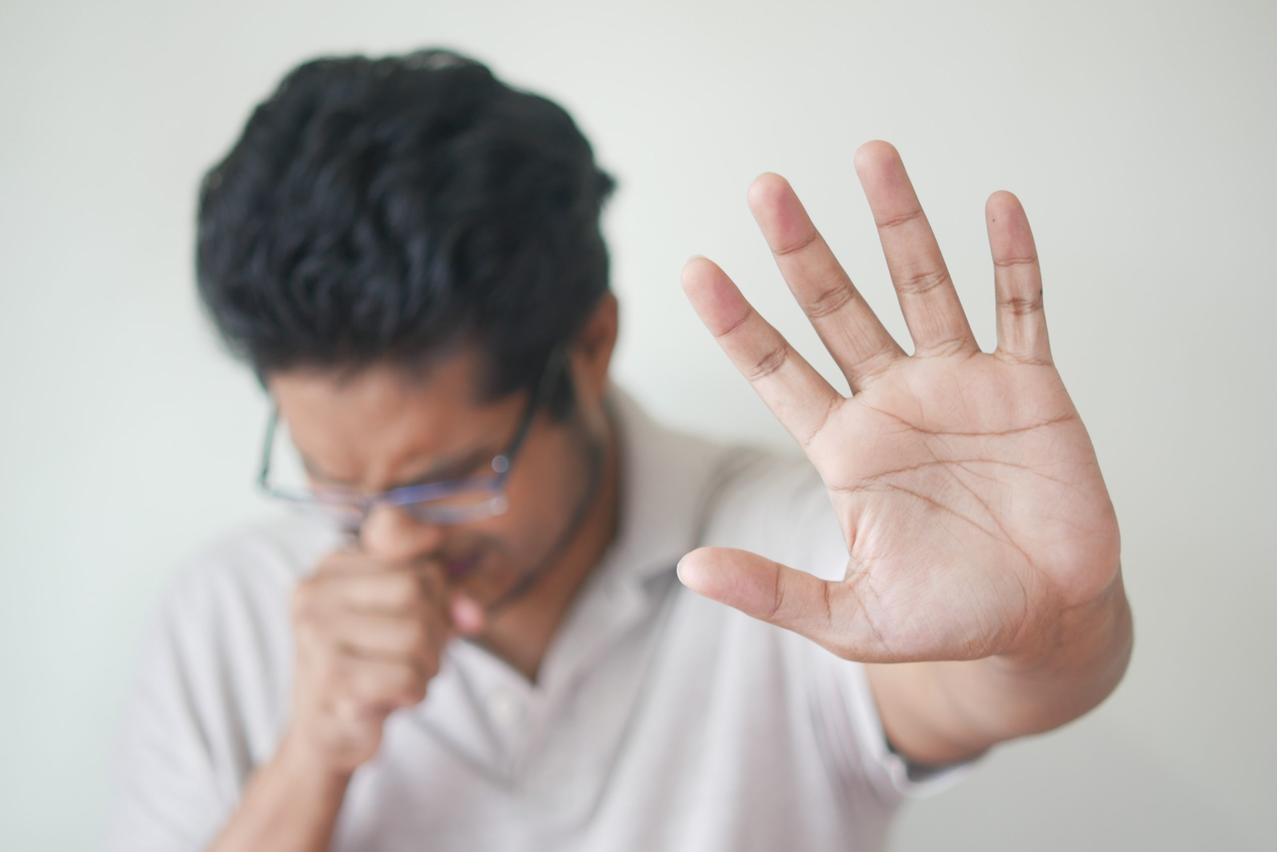 Selective Focus Photo of Coughing Man's Hand