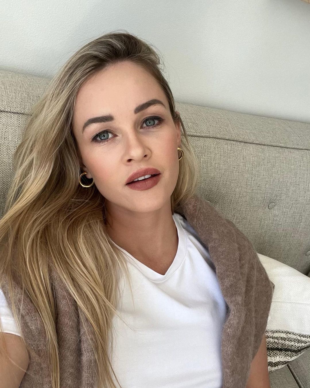 Ambyr Childers wearing a white top and taking selfie